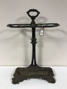 A cast-iron stick stand, together with a brass fire curb.