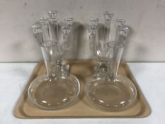 A pair of contemporary glass five way candelabra and a pair of glass vessels