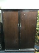 A mahogany double-door fully fitted gentleman's wardrobe.