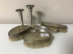A pair of silver backed dressing table brushes together with a small silver dish and a further