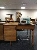 A singer sewing machine in teak table