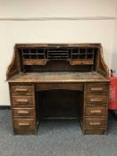An Edwardian oak roll top desk