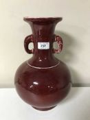 A Chinese sang de boeuf baluster vase with elephant mask handles, character mark to base,