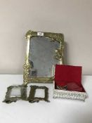 A brass framed Art Nouveau style dressing table mirror, together with two brass picture frames,