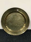 A large circular brass embossed wall plaque together with a framed Max Field Parish print -