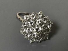 An 18ct white gold diamond cluster ring, the total diamond weight approximately 3.