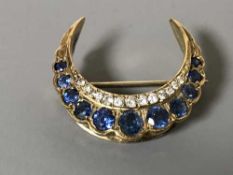 A 9ct gold diamond and sapphire set horseshoe brooch