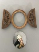 An antique wooden framed painted porcelain plaque depicting a young girl