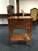 An inlaid yew wood three-drawer side table