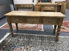 A reclaimed pine three drawer side table
