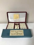 A cased Mahjong set together with a boxed set of Mahjong tile racks