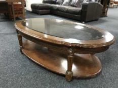 A contemporary shaped two-tier glass top coffee table