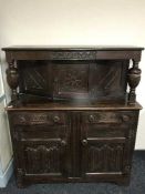 A carved oak buffet back sideboard