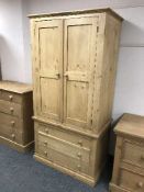 A pine double door wardrobe fitted three drawers