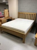An oak 5' rail bed with a John Lewis mattress