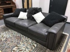 A good quality pair of three-seater brown leather settees with scatter cushions