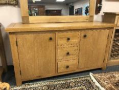 A light oak sideboard fitted with three drawers