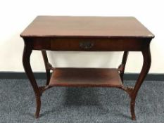 An Edwardian mahogany table fitted a drawer
