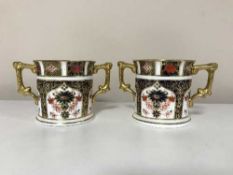 A pair of Royal Crown Derby twin handled mugs