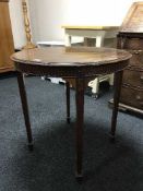 A mahogany occasional table on tapered legs