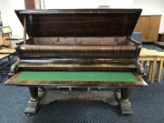 A rosewood baby grand piano converted into a writing desk