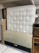 A beige cloth 4'6 bed frame with interior