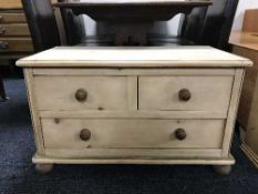 A pine three drawer chest