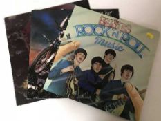 A box of LP records and singles including The Beatles, Meat Loaf, musicals,