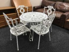 A cast metal garden table and four chairs