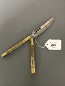 A Filipino Balisong knife with bone grips,