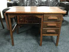 A mid 20th century oak flap sided desk fitted three drawers