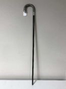 A walking cane with silver mounted horn handle