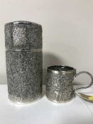 An Indian embossed silver mug decorated with elephants and deer amidst foliage,