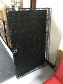 A large folding metal dog cage