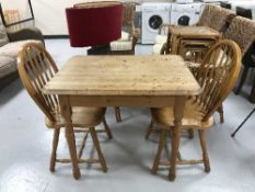 A pine kitchen table and two chairs