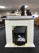 A contemporary electric fire in white surround