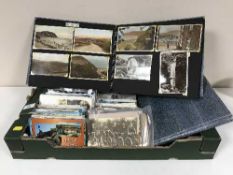 A box of assorted post cards and two post card albums