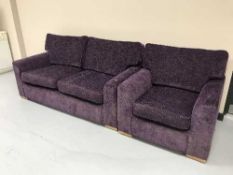 A two seater settee and armchair upholstered in a purple fabric