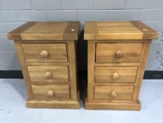 A pair of contemporary pine bedside chests