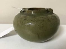 A Chinese Song Period earthenware bowl, in olive glaze with twin handles, height 7.