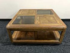 A large square colonial style coffee table inset glass panels
