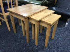 A nest of three beech tables