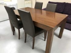 A contemporary table and four brown leather chairs