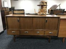 A mid 20th century teak concertina door sideboard
