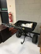 A seed spreading trolley and a bag of De-icer