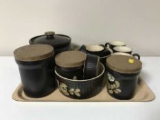 A tray containing fourteen pieces of Denby pottery including oven dishes, storage jars,