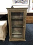 A pine glazed door curio cabinet