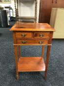 An inlaid yew wood three-drawer side table