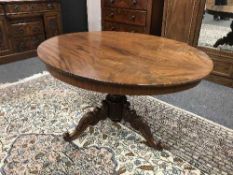 A Victorian mahogany oval breakfast table on carved three-way support