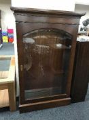 A mahogany Bradley glazed door curio cabinet